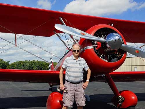 After the flight: Ken and the Stearman in front of red planee Crouch photo)