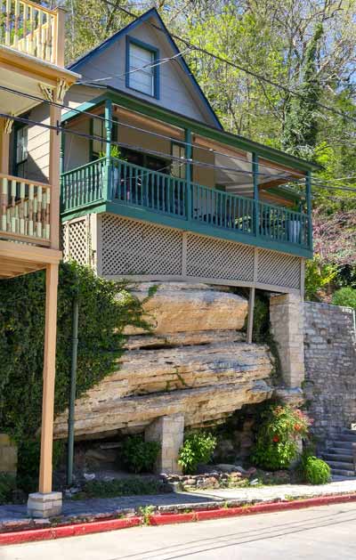 A creatively designed house in Eureka Springs, overcoming the obstacle of a large rock
