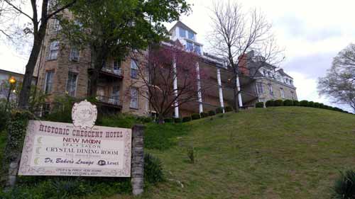 A rear view of the Crescent Hotel as seen from a walking path on the grounds