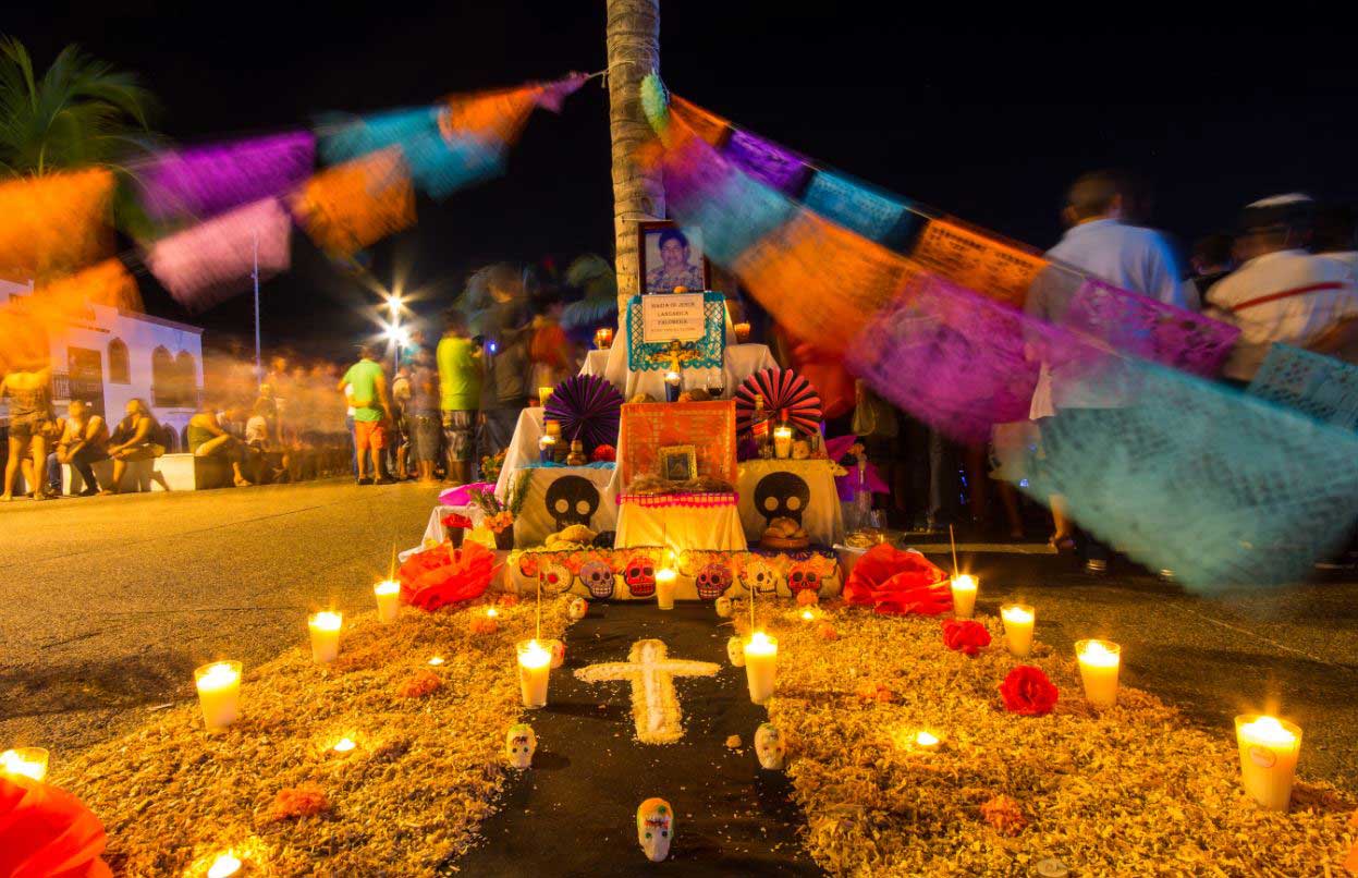 A public altar erected for Dia de los Muertos is decorated with papel picado, or tissue paper decorated with intricate designs. 
