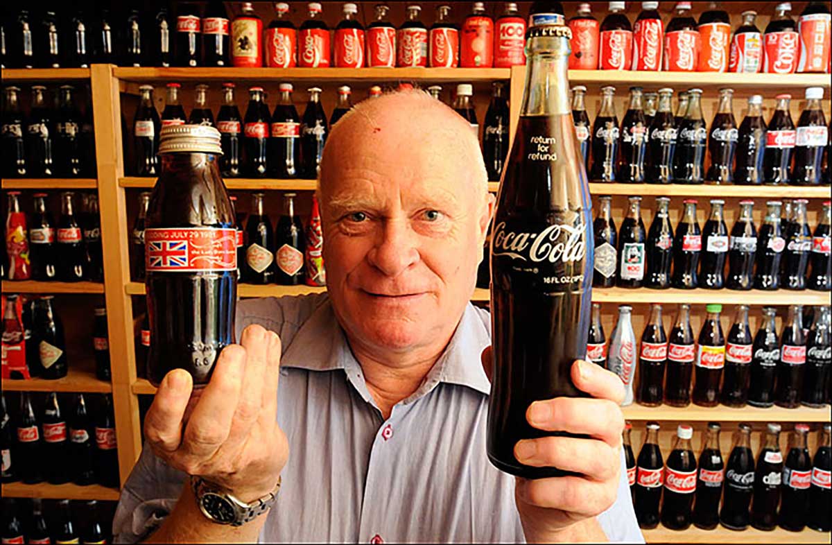 unopened Coca-Cola cans and bottles